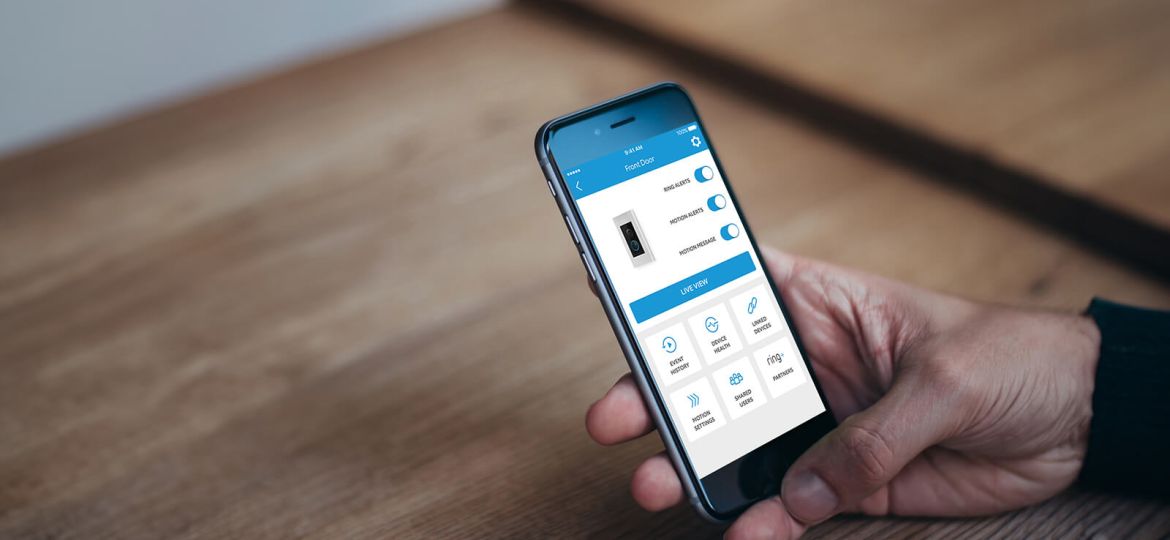 Smartphone displaying Ring app interface with options for Ring Motion Alerts vs Motion Warning for front door security.