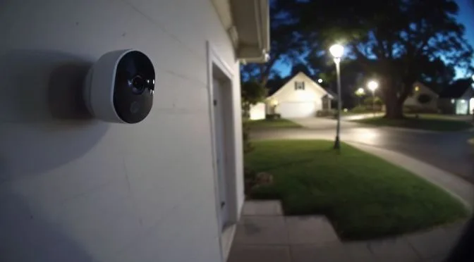 A Ring Camera is mounted on suburban home's exterior wall.