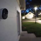 A Ring Camera is mounted on suburban home's exterior wall.